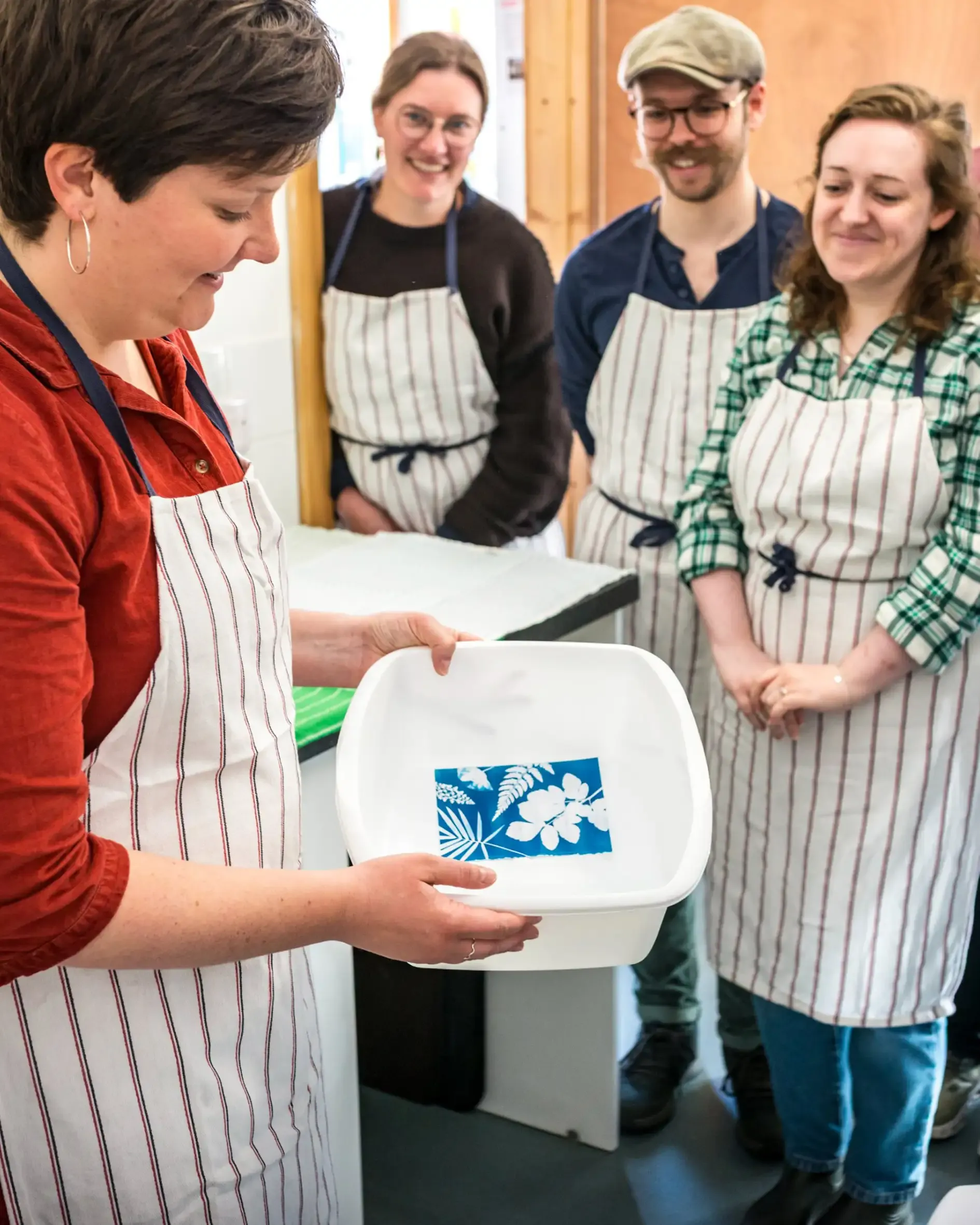 Fiona Clabon rising a cyanotype print during a workshop