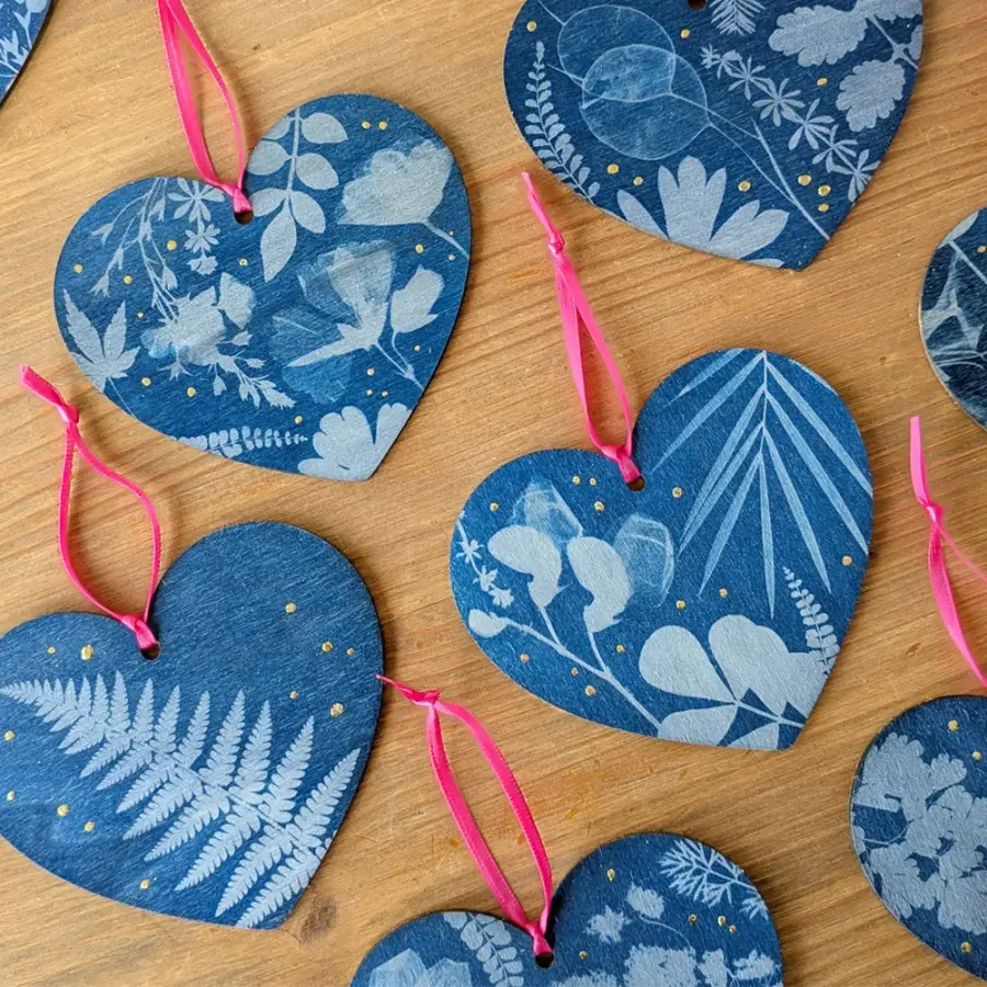 Heart-shaped cyanotype ornaments with botanical patterns