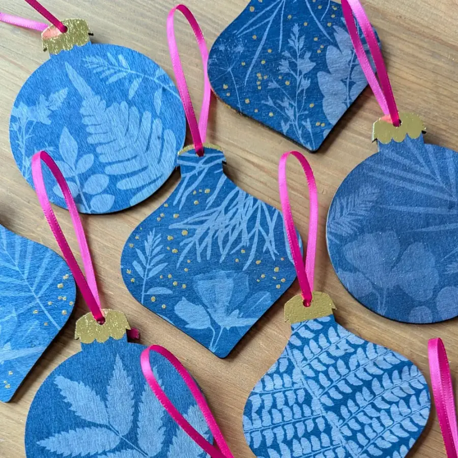 Christmas baubles decorated with blue cyanotype botanical prints
